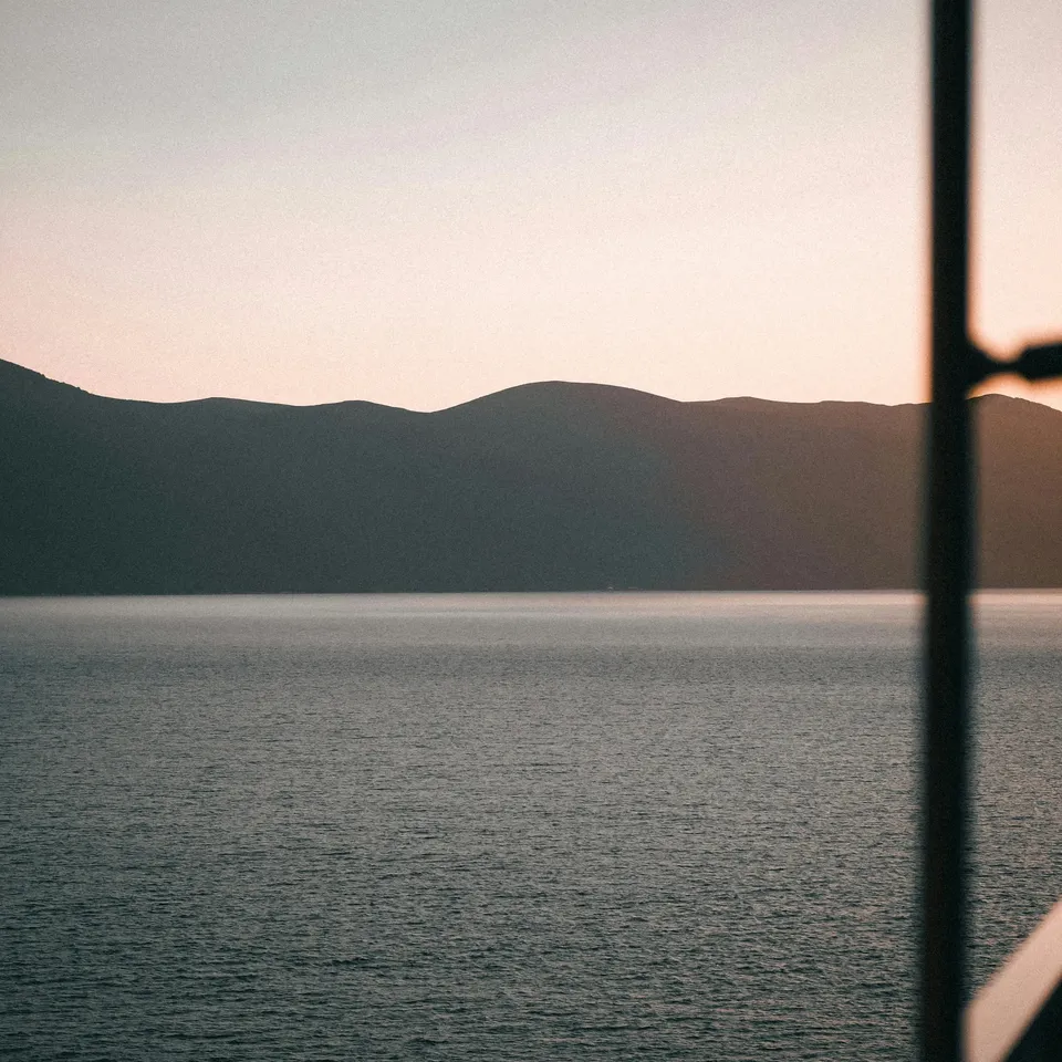 Calm sea and headland at dusk